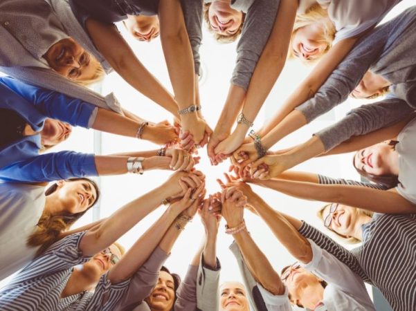 Women with hands in a circle making a heart shape: Menopause Cafe: Navigate Change Together group